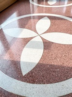 Detail of a white leaf ornament in red terrazzo