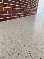 Detail of cast terrazzo by a brick wall