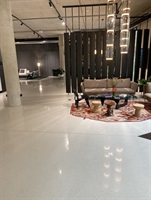 Exhibition space with a round rug on terrazzo flooring
