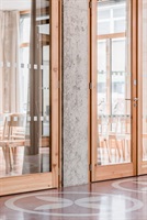 Glazed doors and cast terrazzo flooring in the town hall