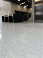 View into the lobby with reception and light terrazzo flooring