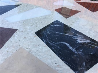 Vložky z černého mramoru v lité terrazzo podlaze